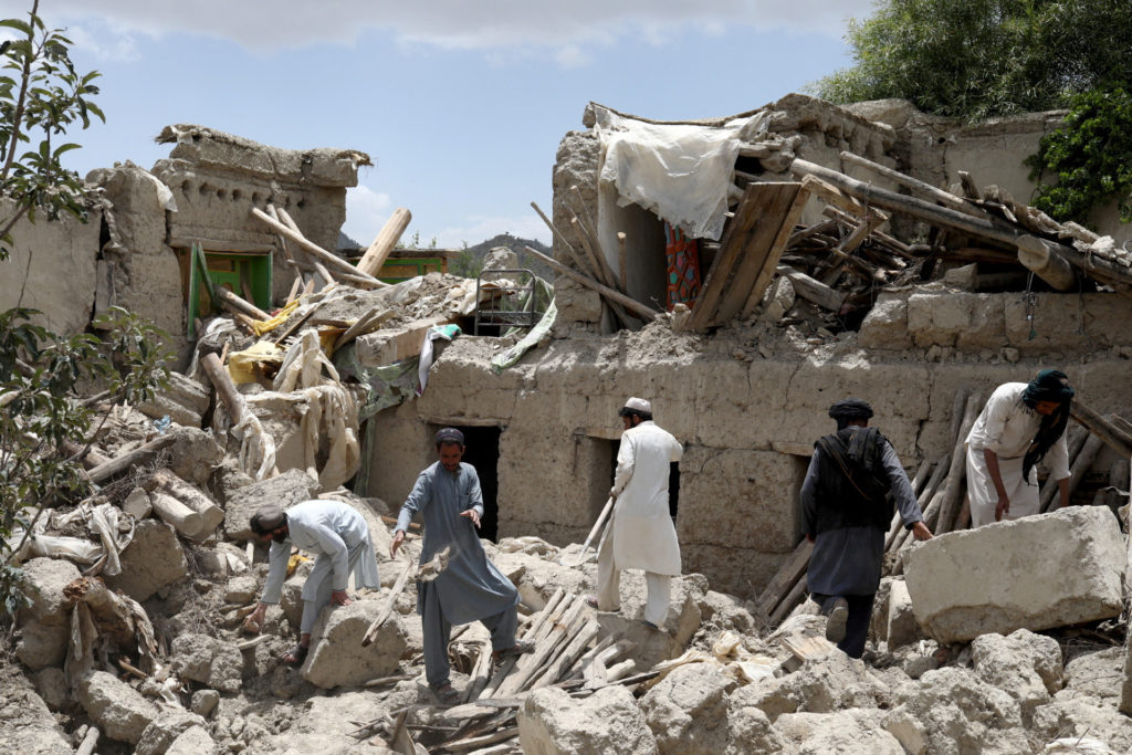 Afghan men search for survivors amidst the debris of a house that was destroyed by an earthquake in Gayan Taliban Pleading for International Help